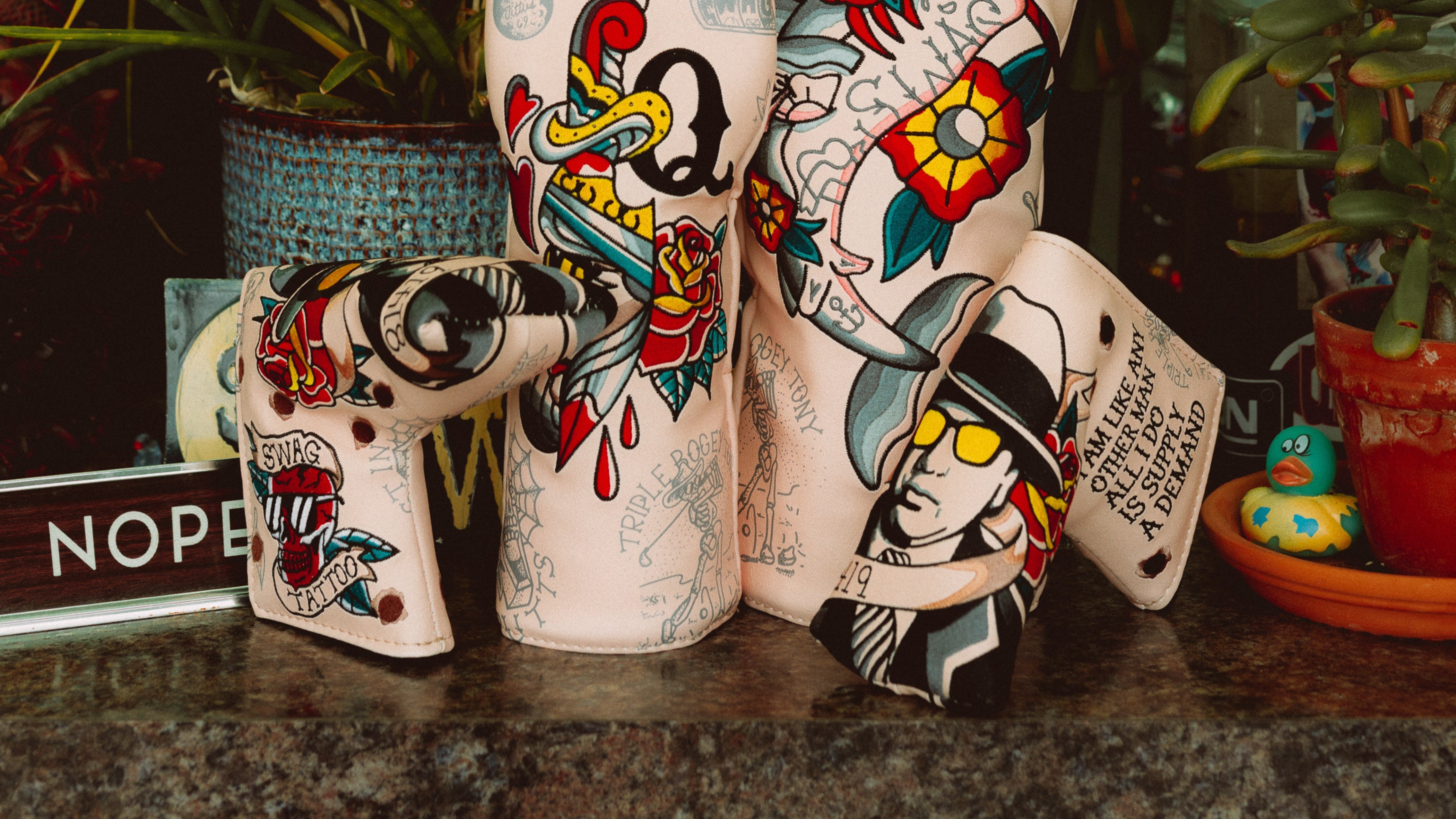 SWAG Golf Tattoo Shop headcover collection featuring wood sets, blades, and mallets.