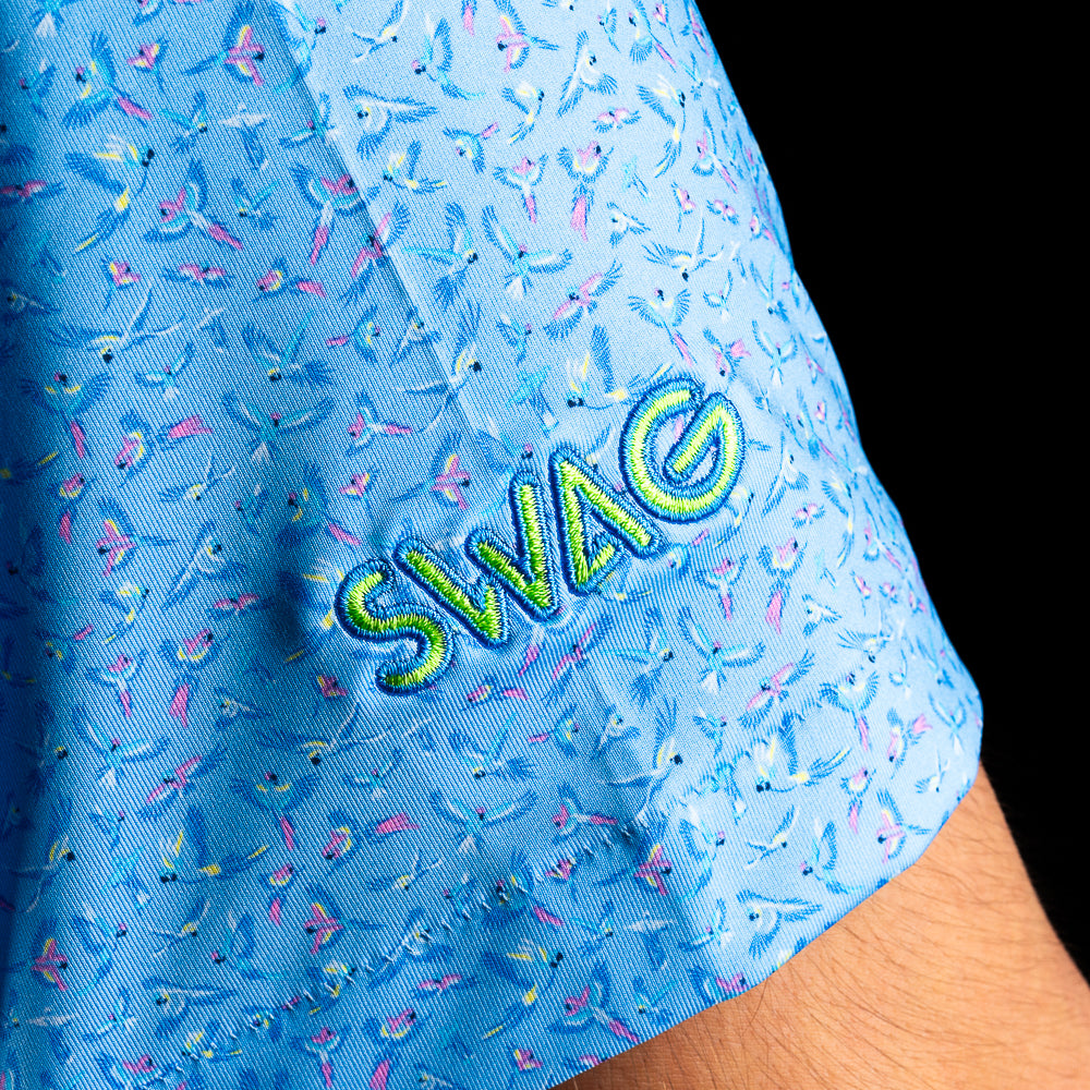 SWAG Golf X Peter Millar polo in flying bird print with neon SWAG skull logo on chest and embroidered SWAG on sleeve.