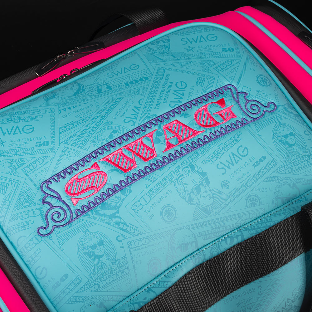 Bubblegum George aqua and neon pink duffel bag accessory with embroidered currency pattern.