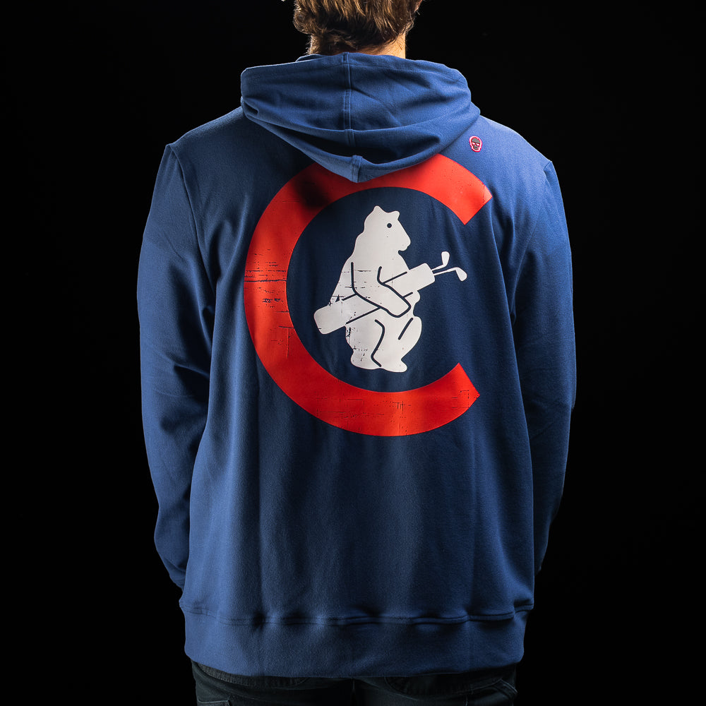 A person shown from the back wearing a navy blue hoodie with a large red and white graphic on the back, photographed against a black background.