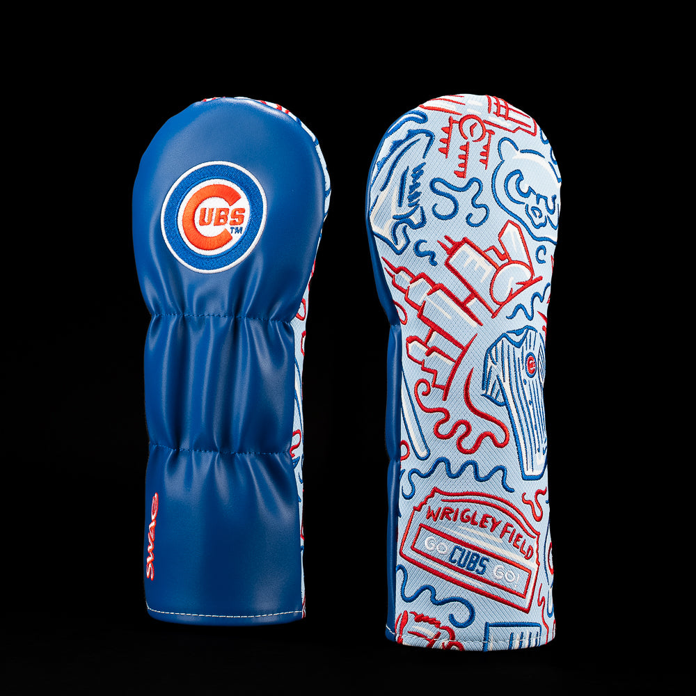 Two blue Chicago Cubs golf club headcovers shown side by side against a black background. The left cover features a large circular Cubs logo, and the right cover has a white base with red and blue graffiti-style line art and a Wrigley Field graphic.