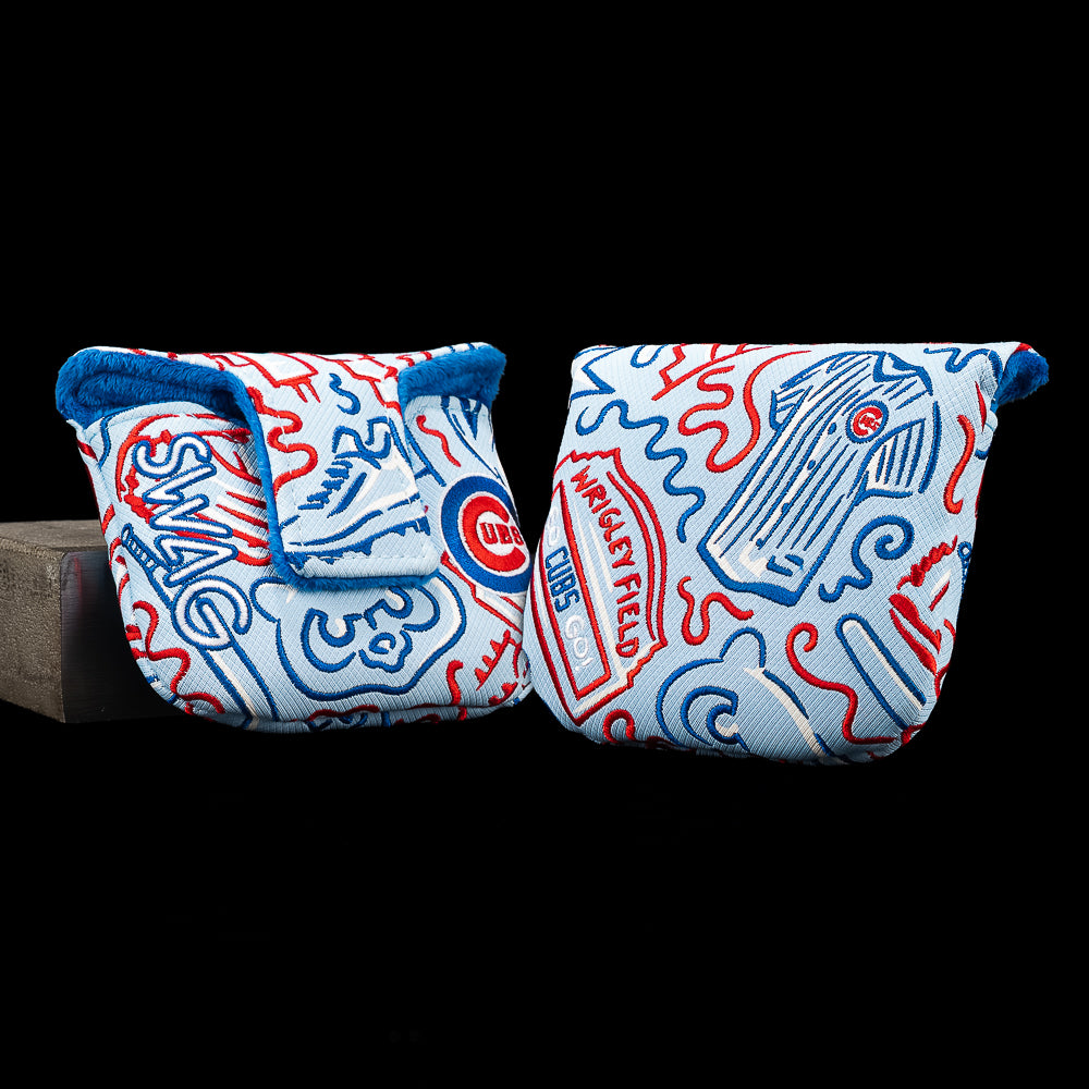 Two golf club headcover sleeves with a Chicago Cubs theme, featuring a light blue background with red and blue line art illustrations and team logos, displayed against a solid black background.