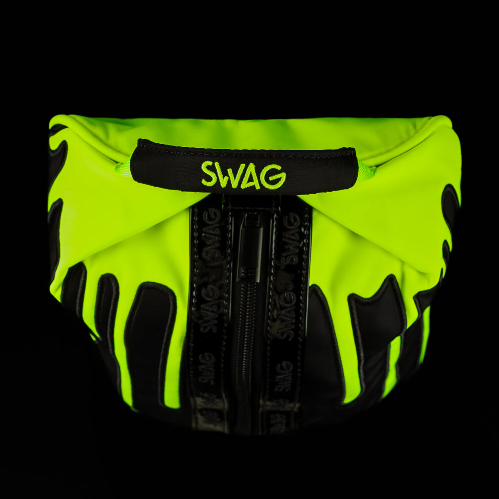 Close-up of SWAG logo handle on neon drip golf shoe bag with black and electric green drip design.