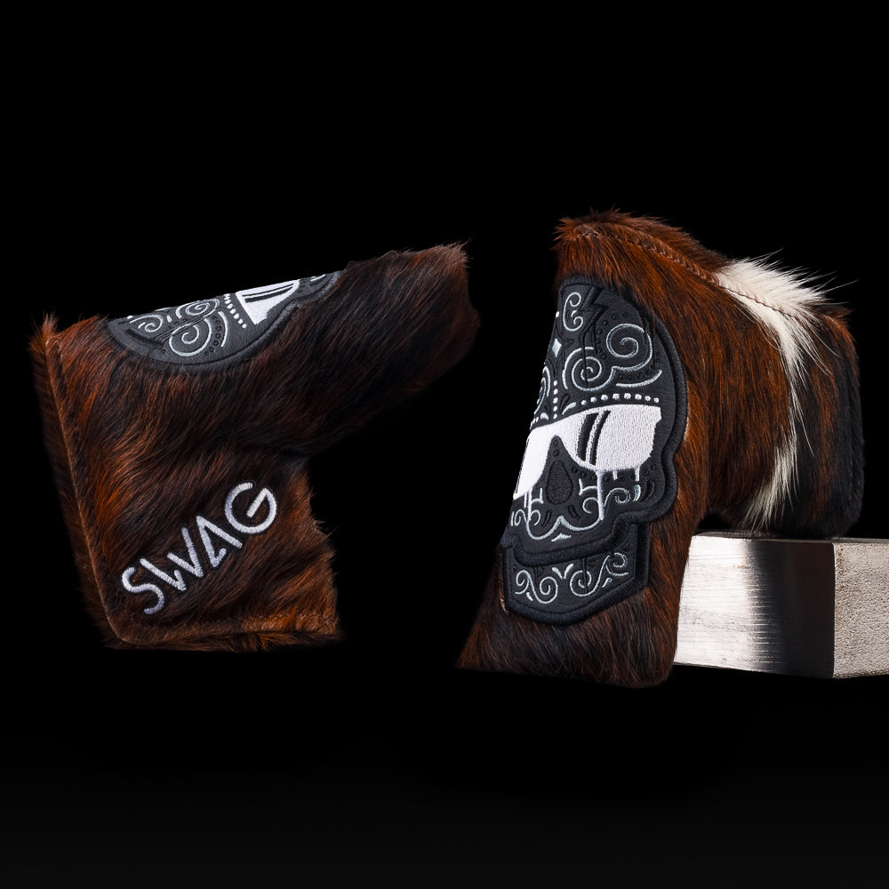 Dripping Sugar Skull Blade putter cover in brown-and-white cowhide pattern with black embroidered skull and SWAG logo.