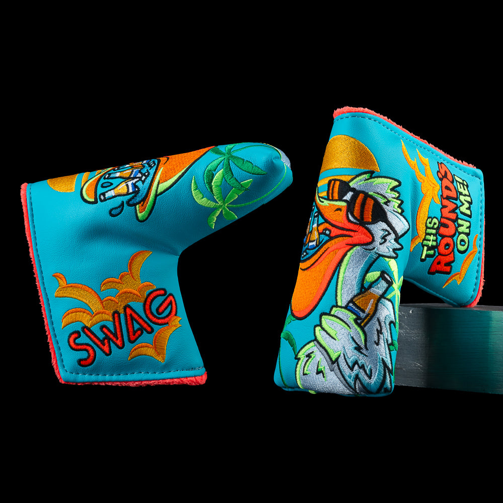 Pelican Blade cover in blue with cartoon pelican graphic, palm accents, and "this round's on me!" graphic.