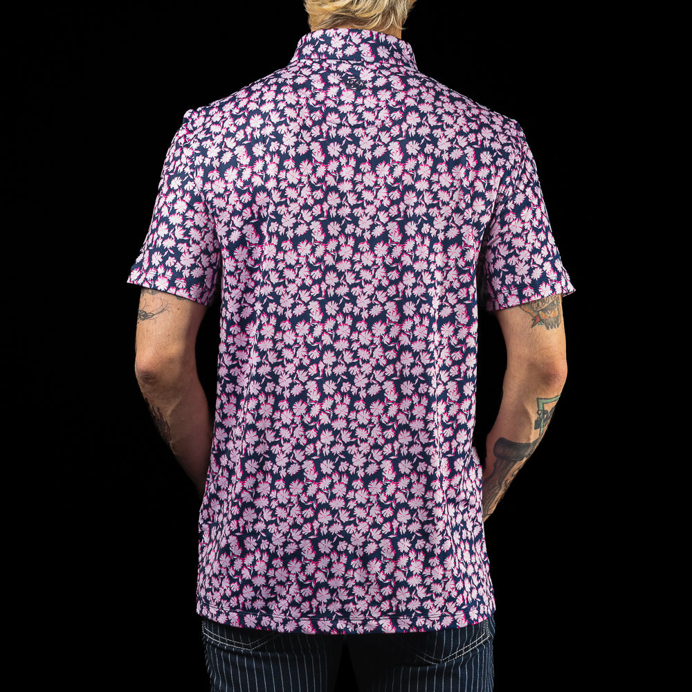 SWAG Golf x G/FORE navy and pink floral tech men's golf polo shirt with Miami Flipper logo over the left chest.