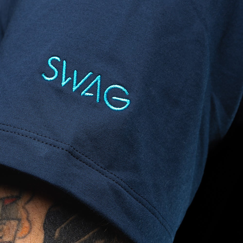SWAG Golf x G/FORE navy men's golf polo featuring dripping SWAG skull logo over the left chest.