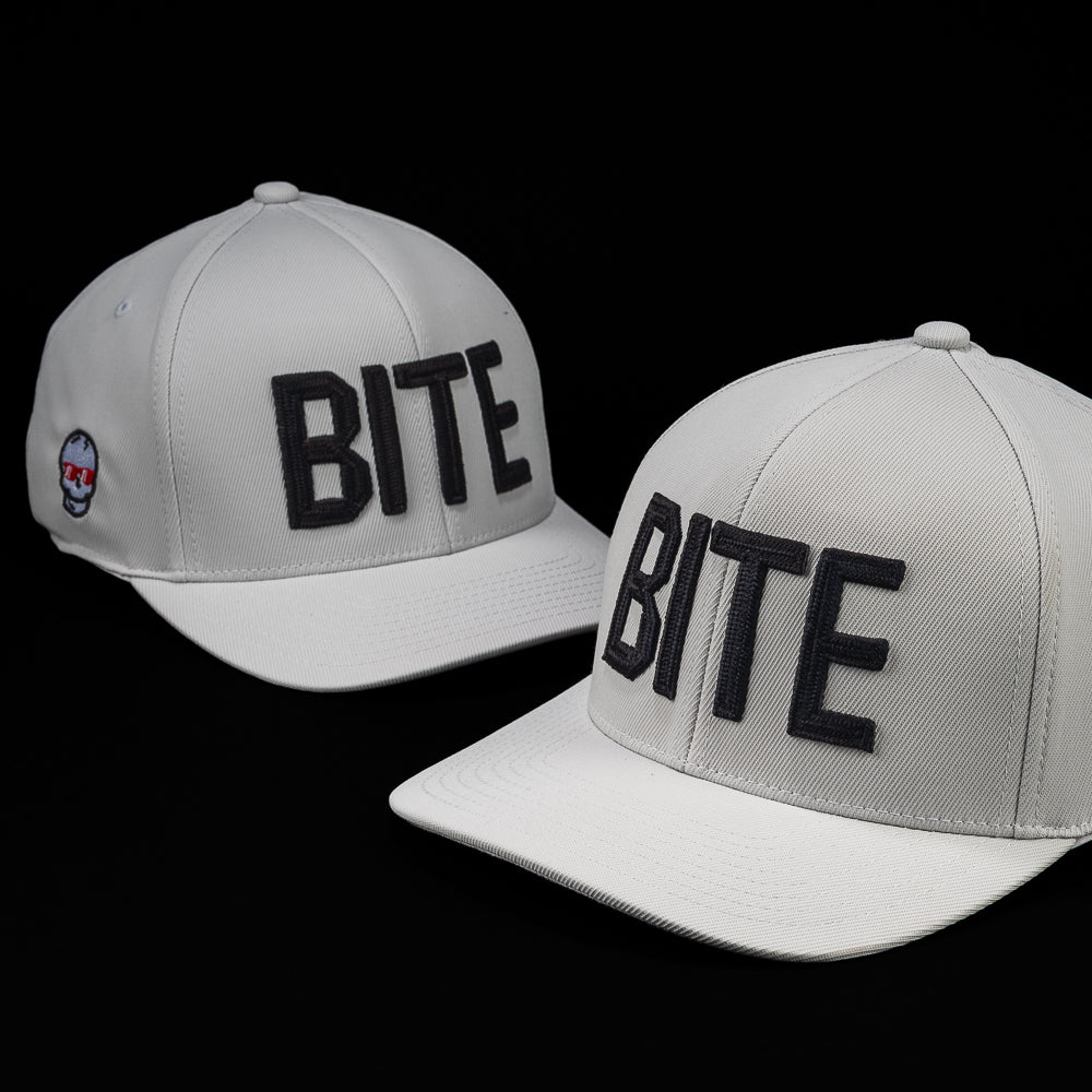 SWAG Golf x G/FORE white flexfit 110 snapback golf hat with BITE letters on the front.