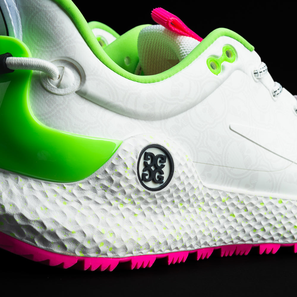 SWAG x G/FORE Men's MG4+ O2 white, neon pink, and neon green golf shoe with stacked SWAG skull design.