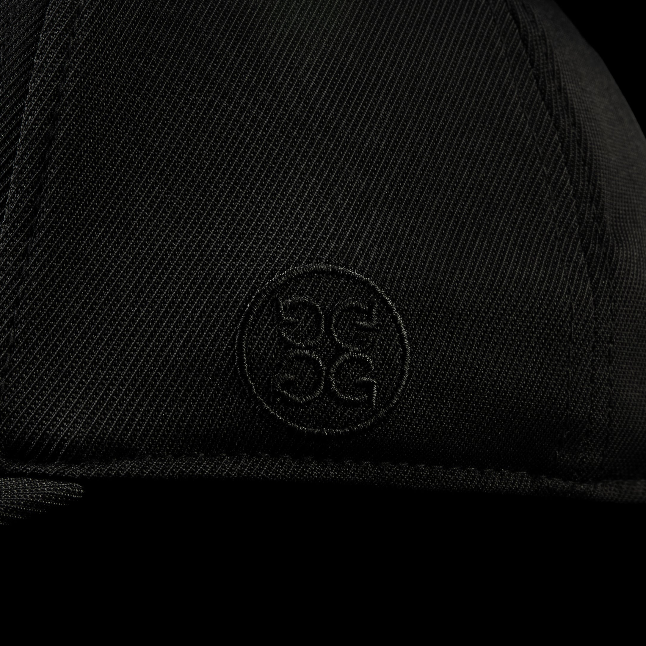 G/Fore flexfit 110 black golf cap with pink 'HAHA' text.