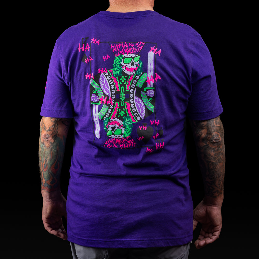 Purple SWAG t-shirt with neon joker skull king graphic and graffiti HA scribbles on the back.