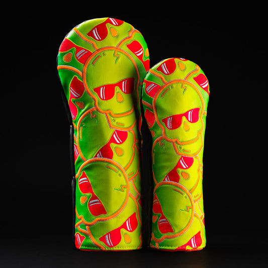 Swag stacked skulls 2.0 green, yellow, red, and orange wood golf head cover set containing a driver and fairway.