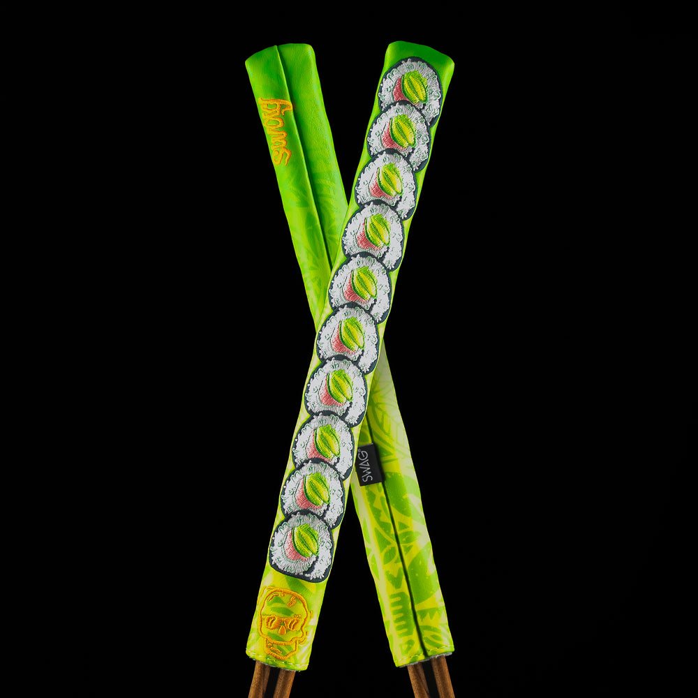 SWAG Golf Roll It alignment stick featuring stacked sushi roll graphics and bold green patterned design.