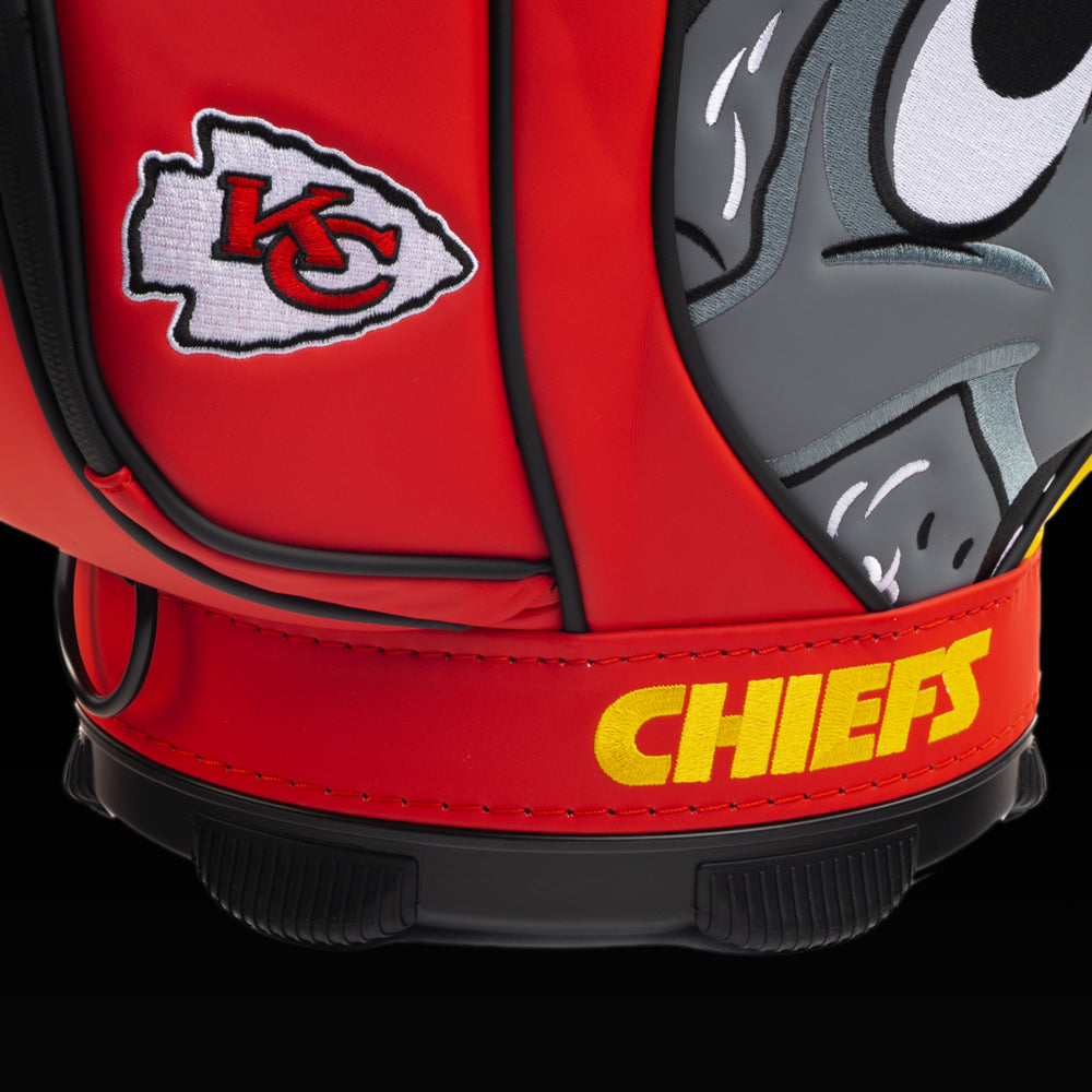 Close-up of the embroidered Chiefs logo on the front pocket with the cartoon wolf artwork in the background.