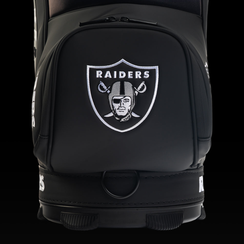 Close-up view of the SWAG Golf Las Vegas Raiders Den Caddy Cooler with an embroidered Raiders shield on the front pocket.