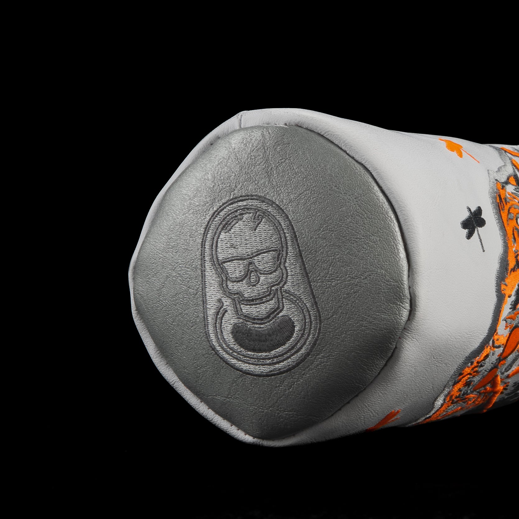 Close-up of Dropzone Light Driver Headcover featuring embossed SWAG skull pull-tab logo in metallic gray leather.