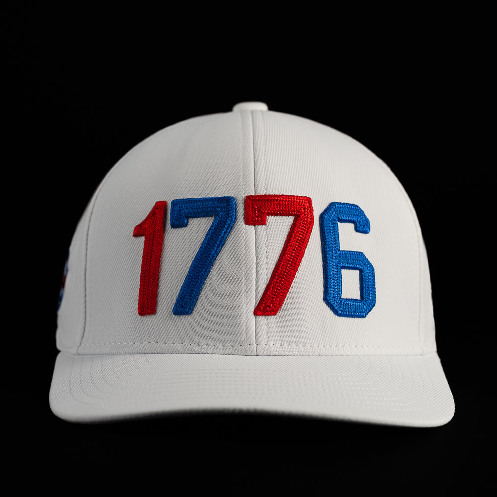 Front view of the 1776 hat featuring bold embroidered 1776 lettering on the crown of a white structured cap.