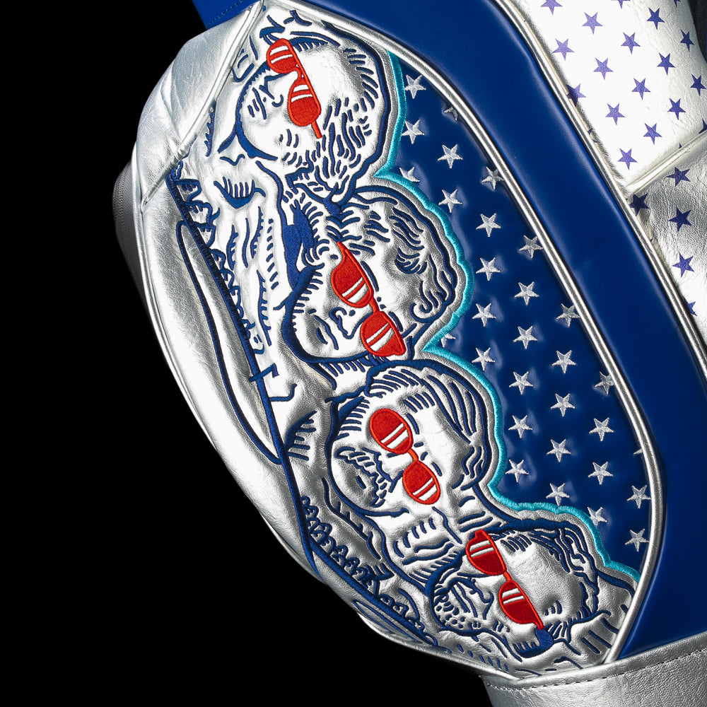 Close-up of the side panel on the Fore! Fathers Den Caddy Cooler featuring detailed Founding Father illustrations, patriotic graphics, and embroidered accents.