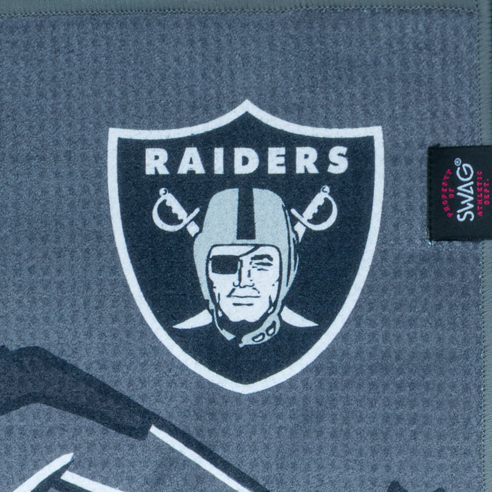Golf towel with warrior design and Las Vegas Raiders logo on a dark background.