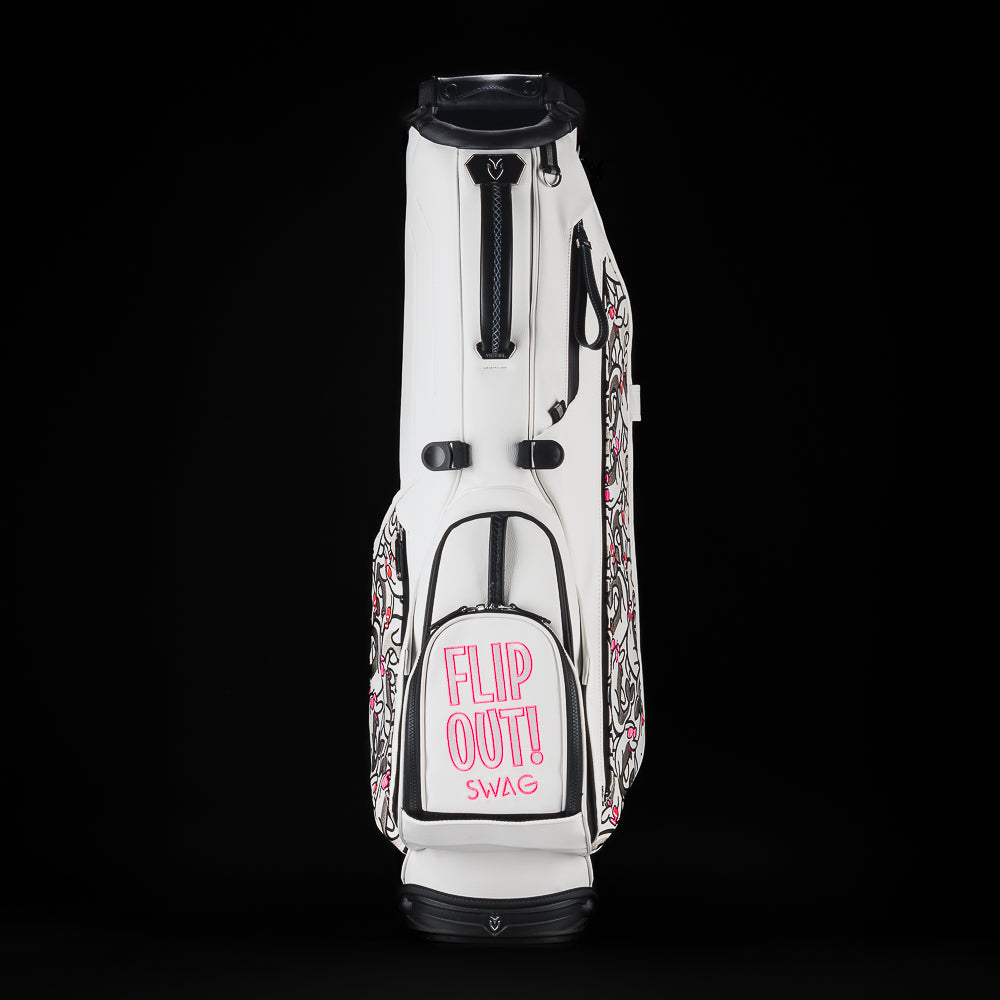 SWAG Golf x Vessel white stand bag with Stacked grey and pink flipper designs and "Flip Out" text on the ball pocket.