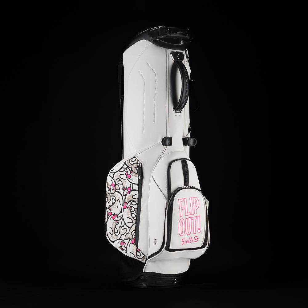 SWAG Golf x Vessel white stand bag with Stacked grey and pink flipper designs and "Flip Out" text on the ball pocket.