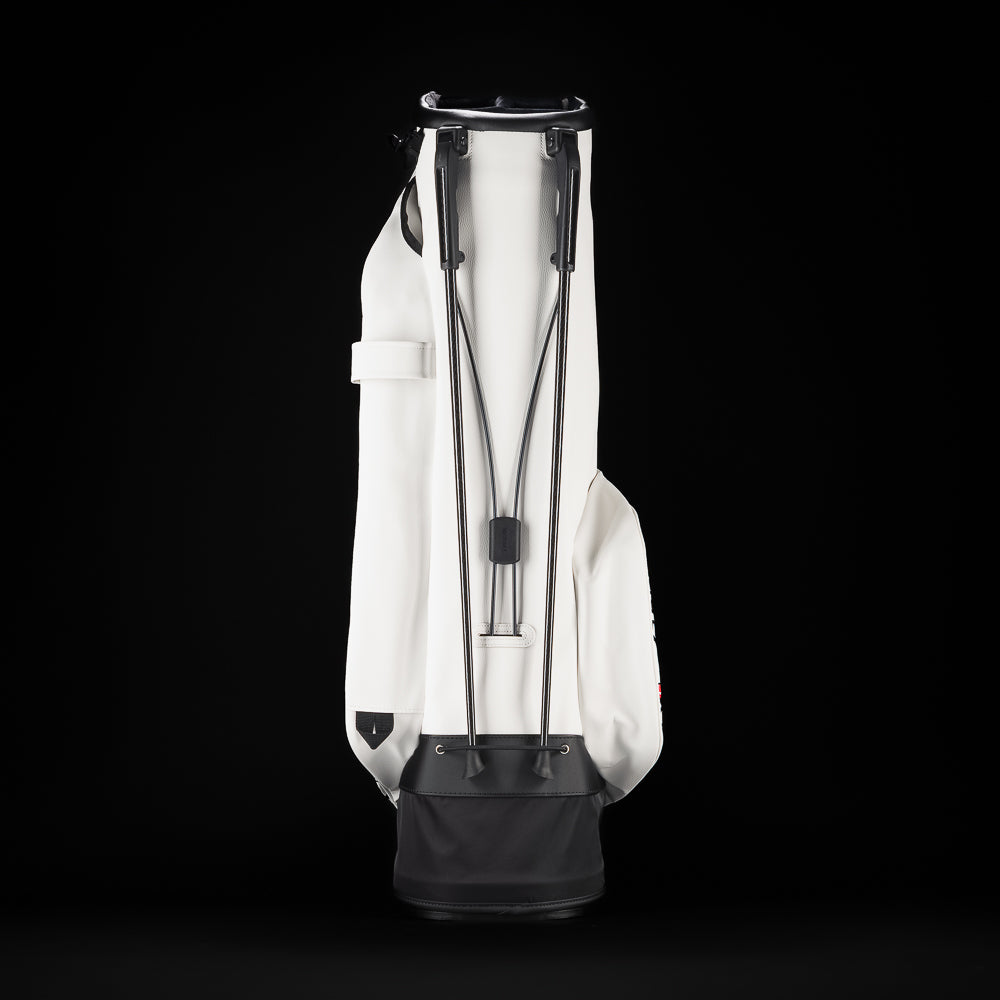 SWAG Golf x Vessel white stand bag with Stacked grey and pink flipper designs and "Flip Out" text on the ball pocket.