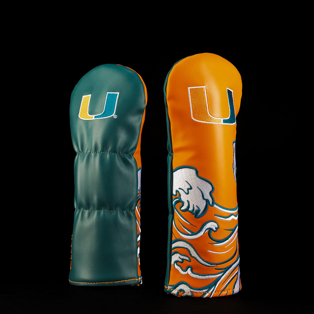 Green and orange Miami Hurricanes fairway golf headcover featuring the split-color U logo and bold ocean wave artwork in orange, green and white.