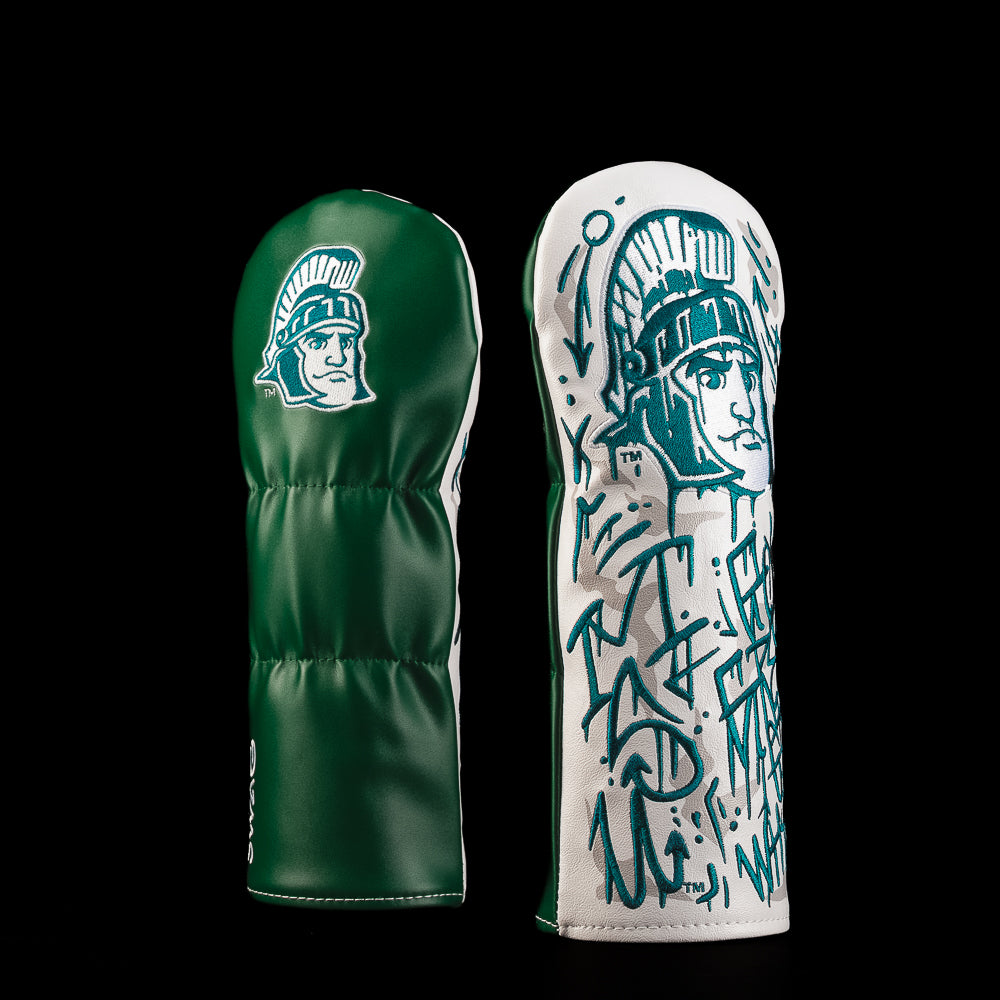 Green and white Michigan State fairway golf headcover featuring the Spartan helmet logo and hand-drawn Spartan warrior artwork with graffiti-style detailing.