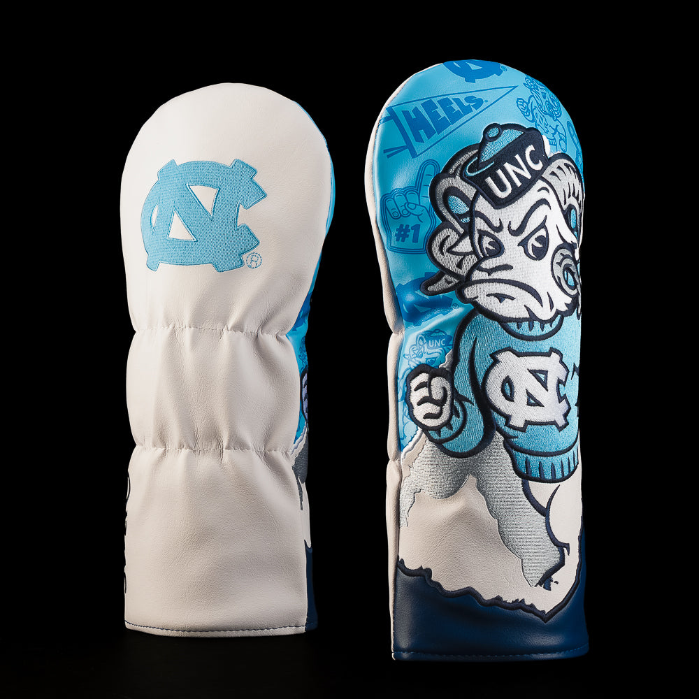 White and Carolina blue UNC driver golf headcover featuring the interlocking NC logo and large illustrated Rameses mascot artwork in a UNC sweater.