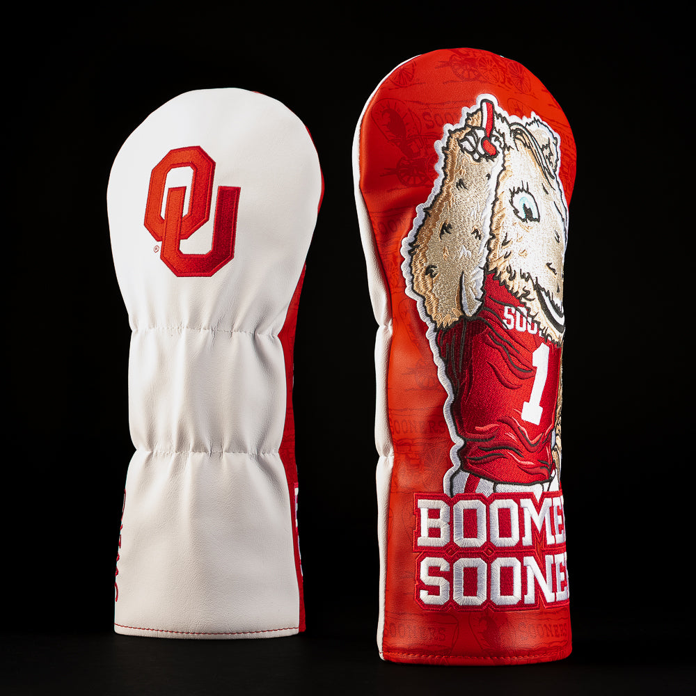 White and crimson Oklahoma Sooners driver golf headcover featuring the OU logo, Sooner mascot artwork and bold “Boomer Sooner” lettering.