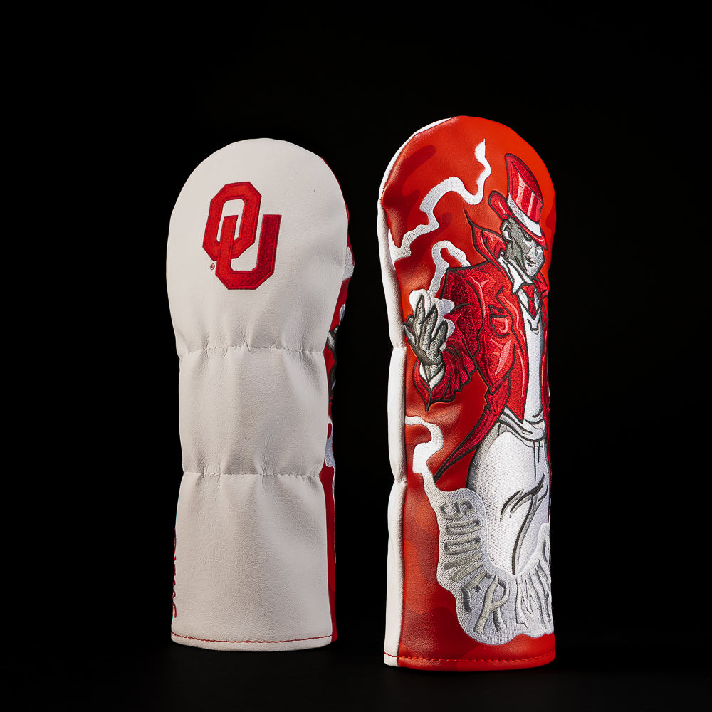 White and crimson Oklahoma Sooners fairway golf headcover featuring the OU logo and detailed crimson football player illustration.
