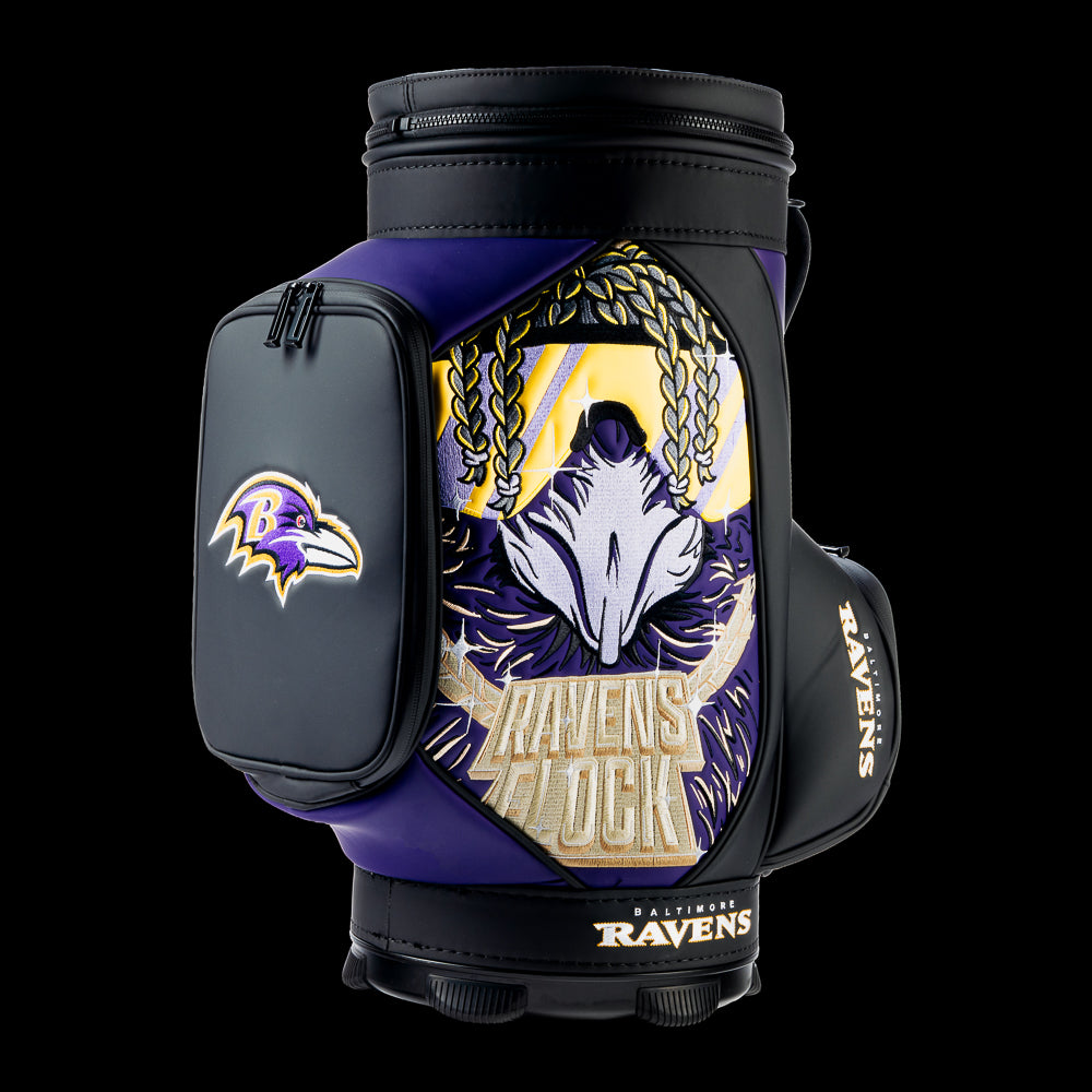 SWAG Golf Baltimore Ravens Den Caddy Cooler featuring bold "Ravens Flock" artwork with a raven skull, purple and black graphics, and an embroidered Ravens logo front pocket.