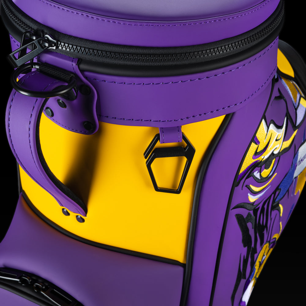 Close-up of the Minnesota Vikings Den Caddy Cooler zipper, handle, and purple and gold panels.
