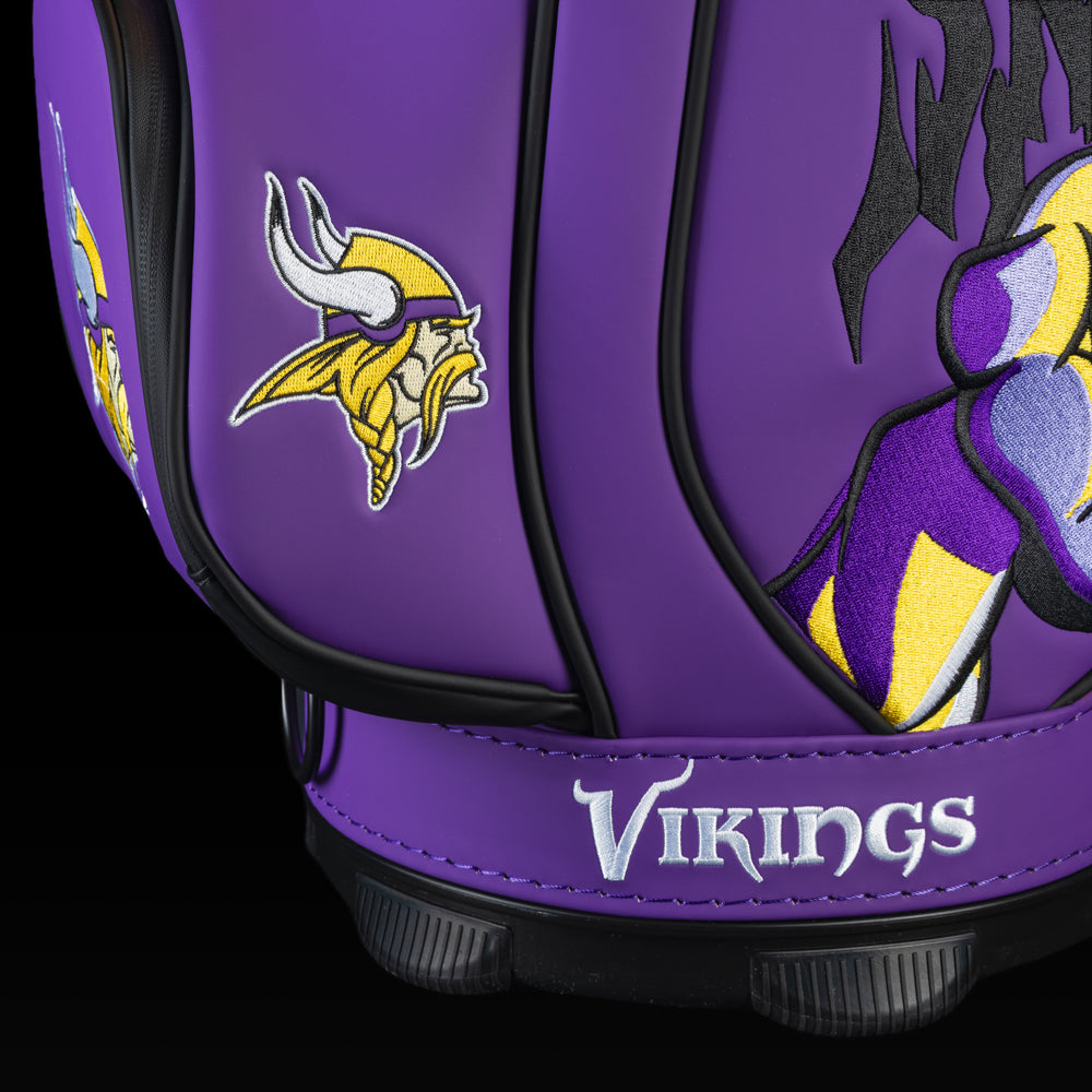 Close-up of the embroidered Vikings logo on the front pocket with the Viking warrior artwork in the background.