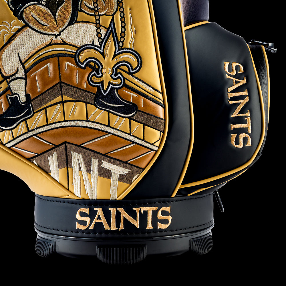 Close-up of the embroidered Saints typography on the front pocket with the vintage Saints fan artwork in the background.