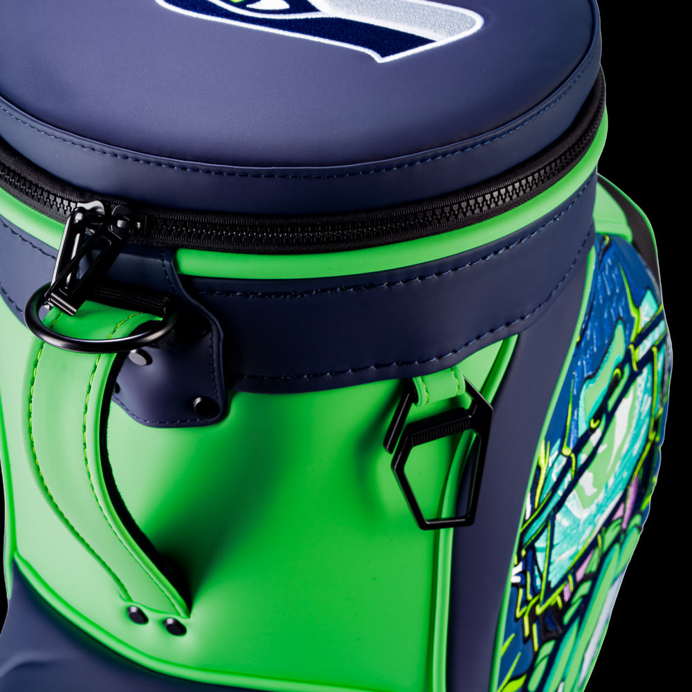 Close-up of the Seattle Seahawks Den Caddy Cooler zipper, handle, and navy and action green panels.
