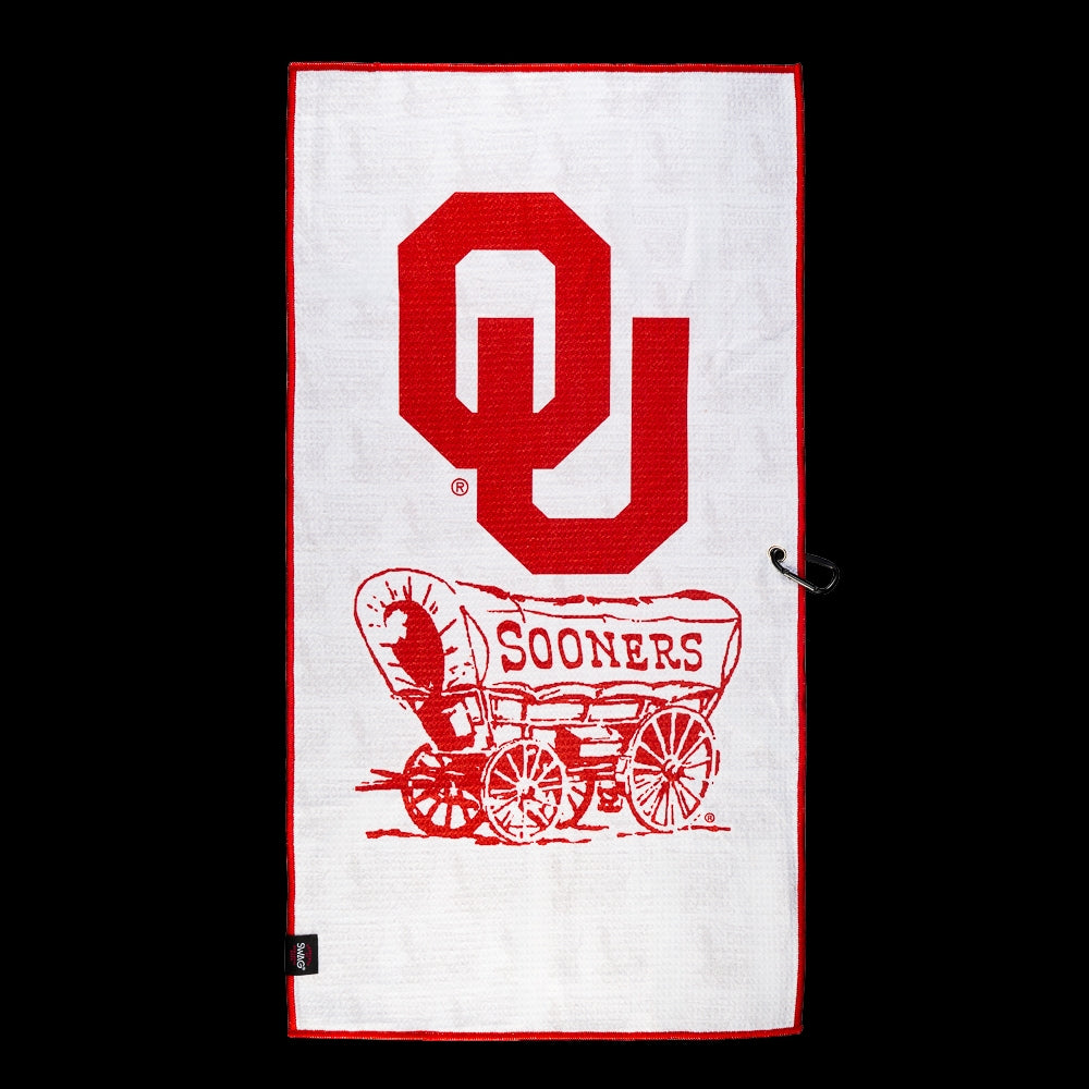 A white rectangular towel with a red border, featuring a large red 'OU' logo and a red covered wagon graphic with 'SOONERS' text, shown against a black background.