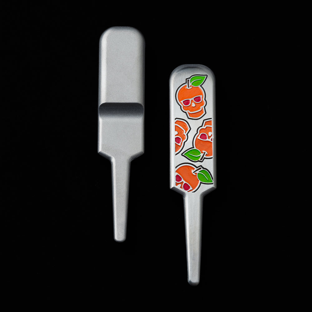 SWAG Golf peach skull stainless steel golf divot tool accessory.