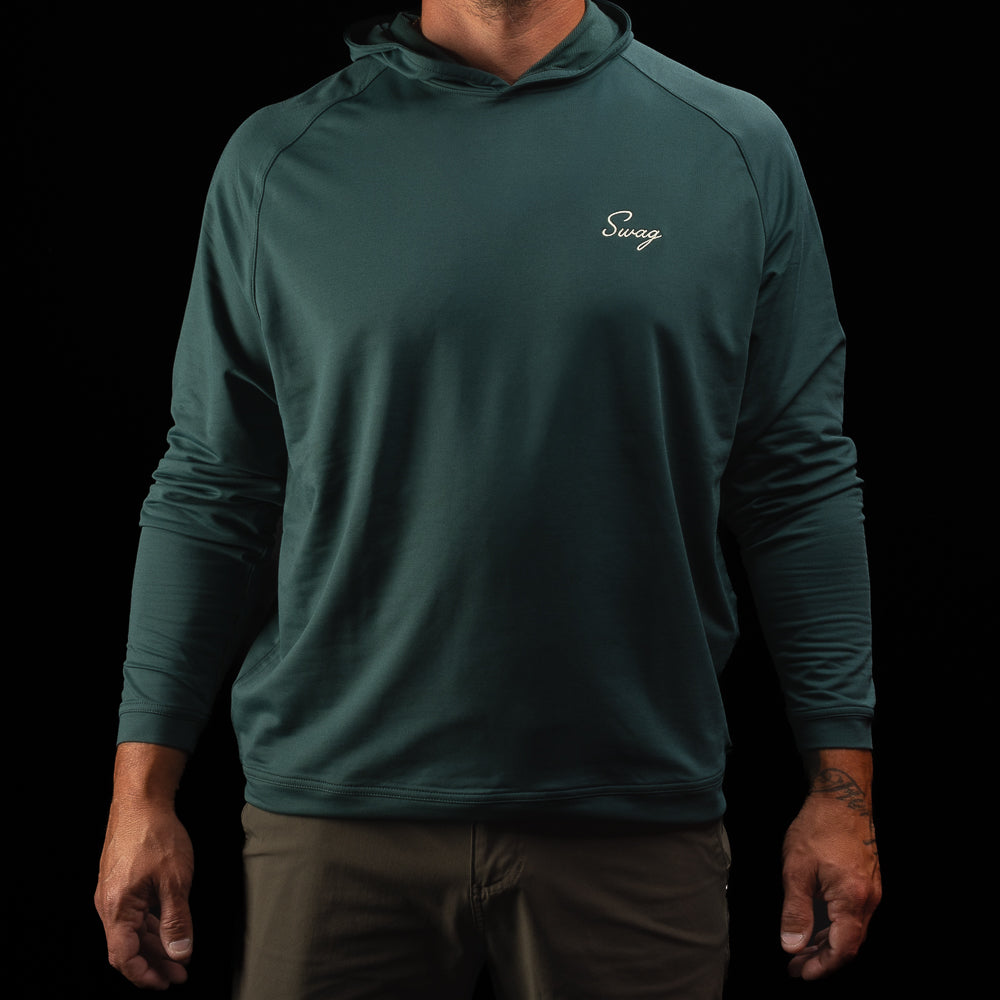 Person wearing a nordic green long sleeve performance golf hoodie with 'Swag' logo.
