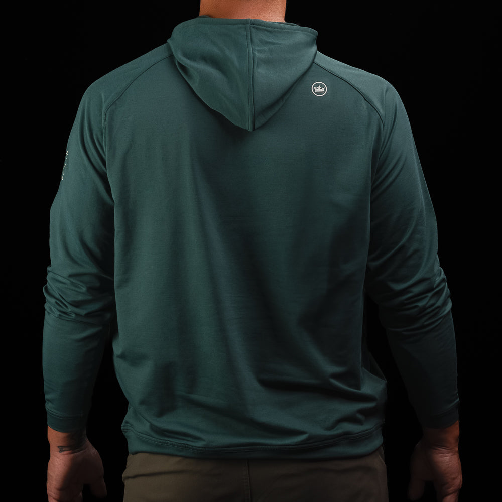 Person wearing a nordic green long sleeve performance golf hoodie with 'Swag' logo.