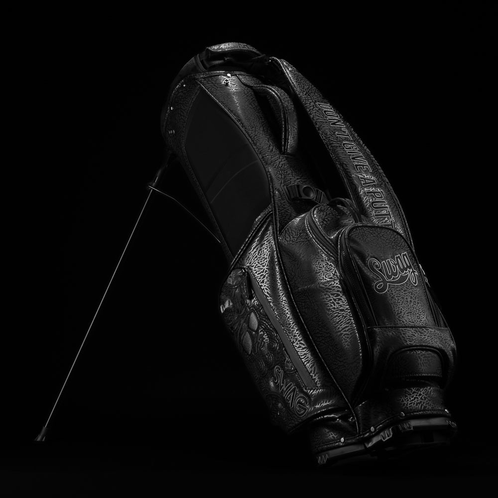 SWAG Golf all black golf stand bag with greatest hits designs on the side panels.