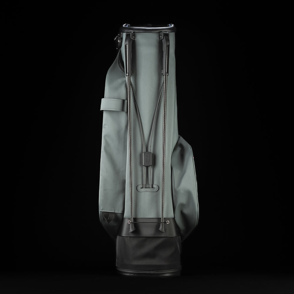 Gray SWAG Golf x Vessel golf stand bag with colorful dollar bill themed designs on a black background.