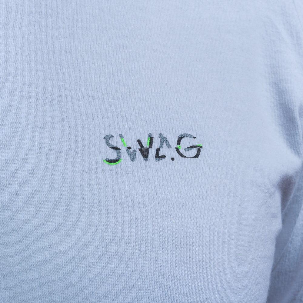 Close-up of SWAG logo on white Glitched Out Benji t-shirt in green and gray detail with glitch styling.