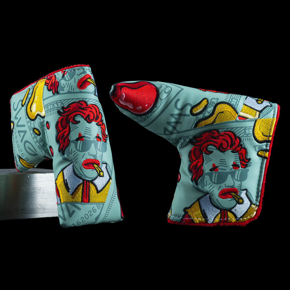 SWAG Golf McFlation Blade Cover featuring vandalized bill artwork, red-haired cartoon portrait with sunglasses, dripping accents, and bold red and yellow detailing.