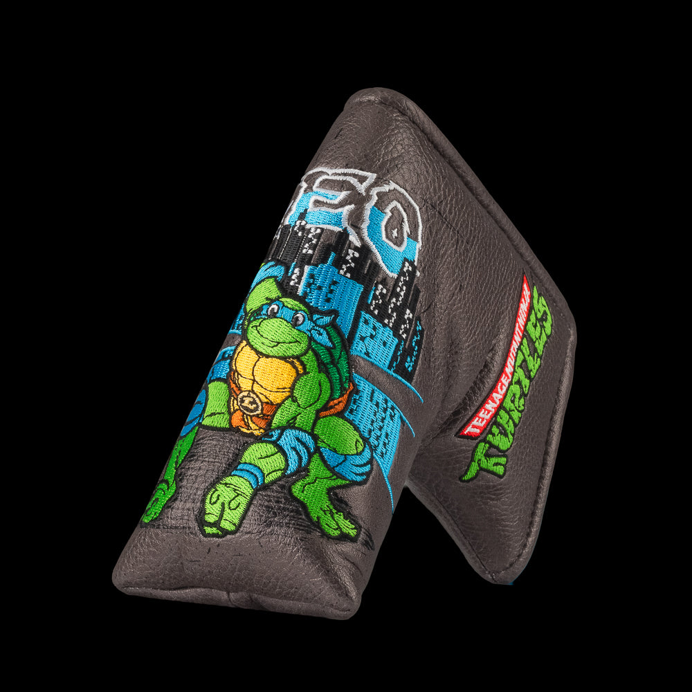 TMNT Leo blade putter cover with swords and blue cityscape detailing.