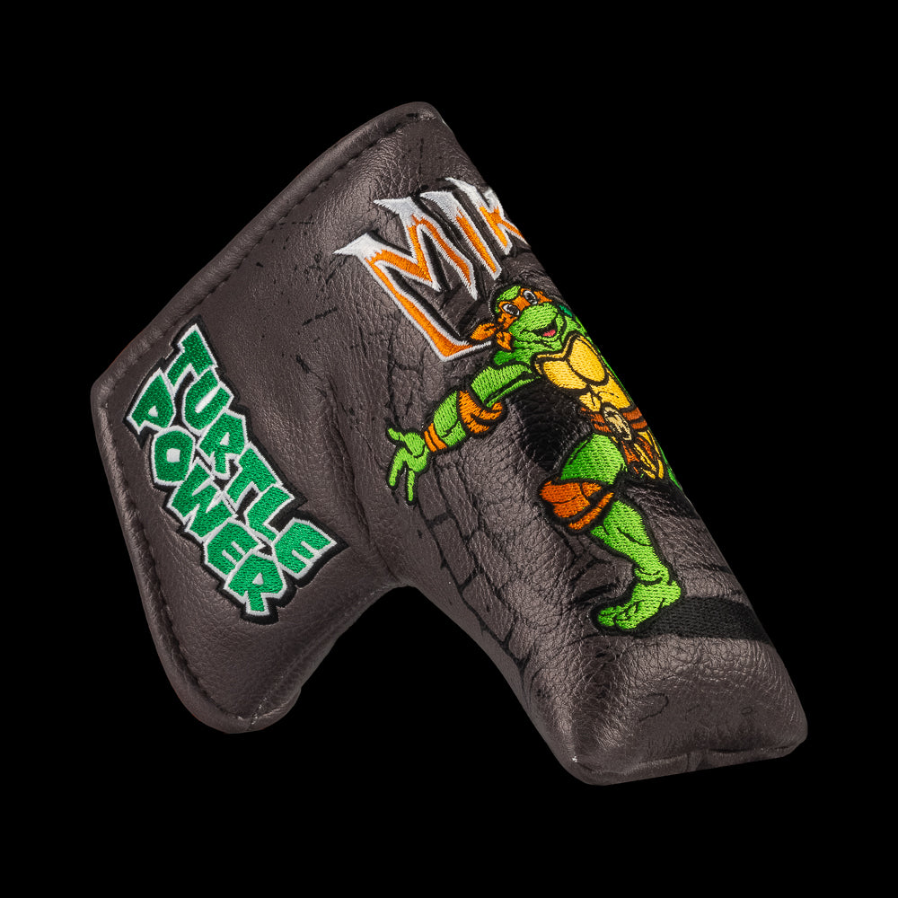 TMNT Mikey blade putter cover with neon green details, bold cartoon design, and Teenage Mutant Ninja Turtles style.