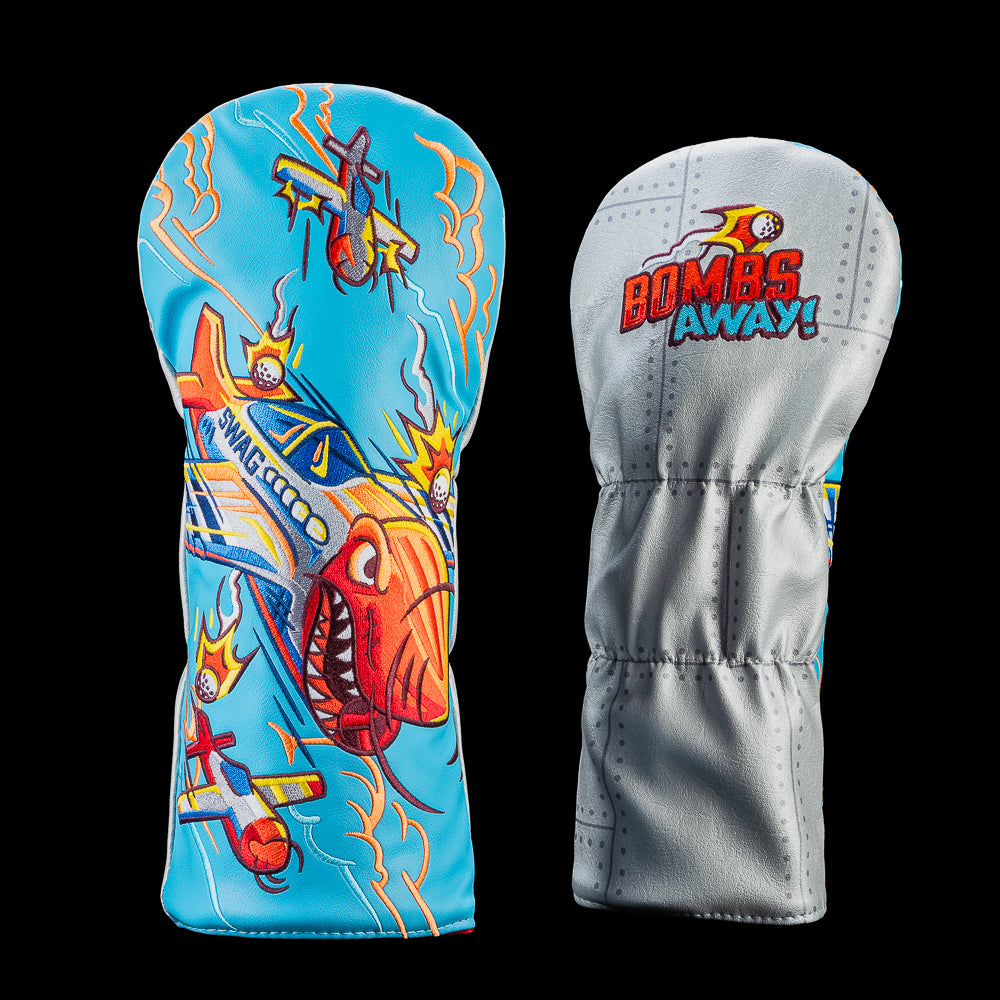 SWAG Golf Bombs Away! driver cover featuring fighter planes, exploding golf balls, and aviation-inspired artwork on a blue background with a gray back panel.