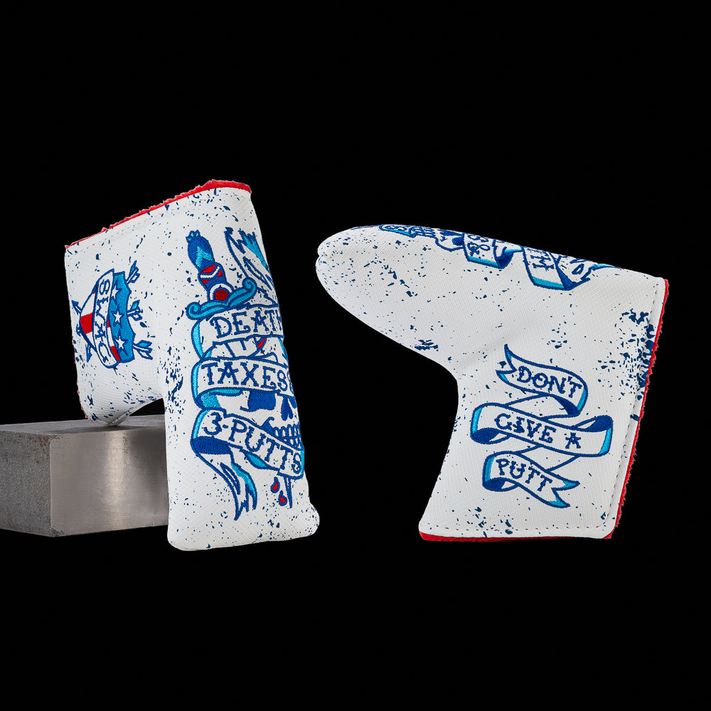 SWAG Golf Death, Taxes & 3-Putts blade putter cover featuring a tattoo-style skull and dagger graphic with Americana artwork and blue distressed detailing.