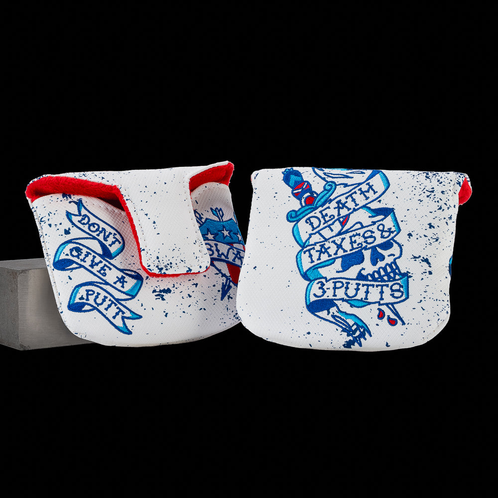 SWAG Golf Death, Taxes & 3-Putts mallet putter cover featuring a tattoo-style skull and dagger design with distressed Americana graphics and blue artwork.