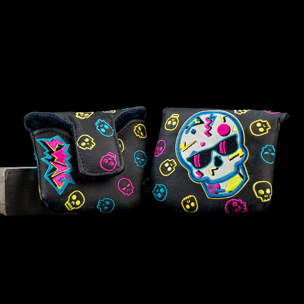 Black mallet putter cover featuring a neon skull wearing sunglasses with colorful 90s-inspired graphics and repeating skull pattern details.